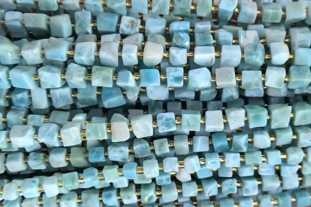 Larimar Stone Benefits shown in natural Larimar cube gemstone beads with soft blue patterns
