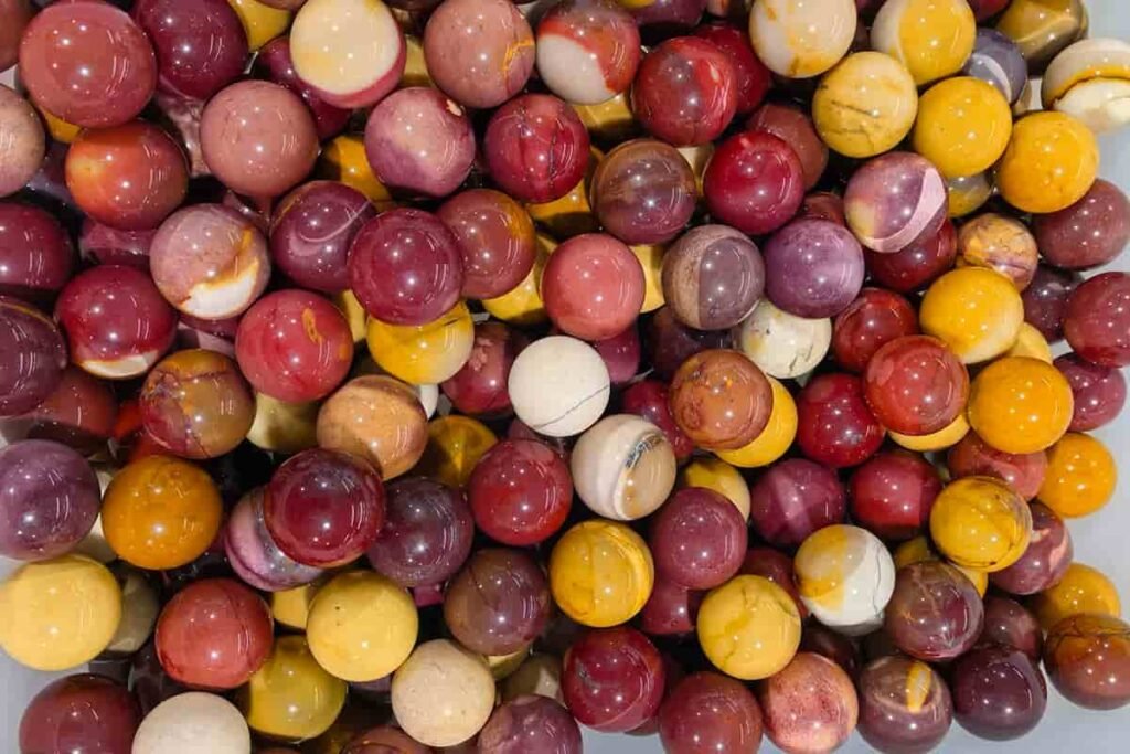Mookaite meaning polished spheres in red, yellow, and cream jasper tones