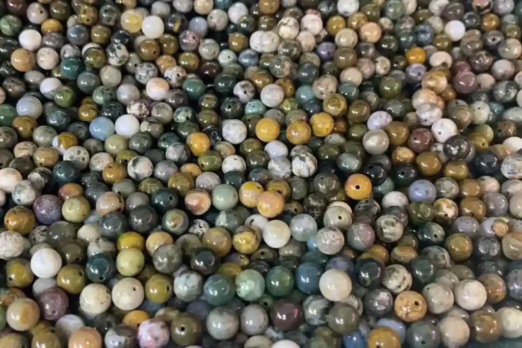 Ocean Jasper Meaning reflected in loose beads with mixed earthy colors and orb patterns