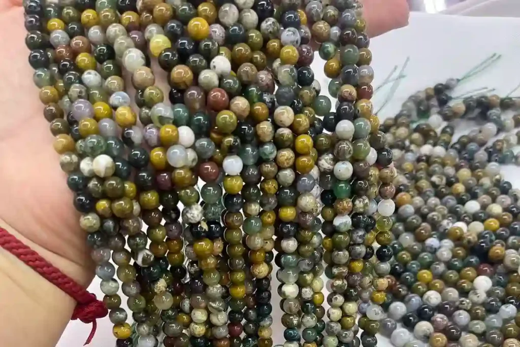 Ocean Jasper Meaning displayed by Ocean Jasper beads on hand with natural texture