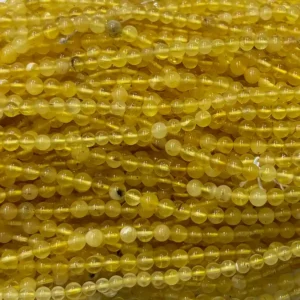 Close-up of natural 4mm amber beads wholesale strands showing high-quality polished finish for jewelry making.