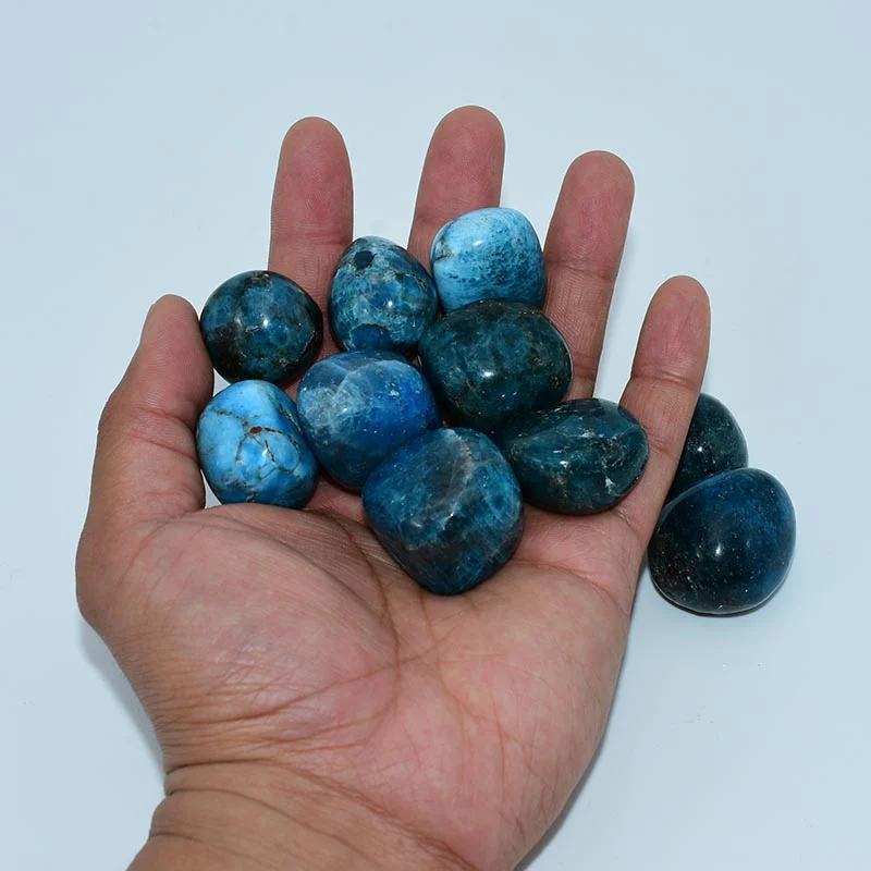 Blue Apatite Tumbled Stone Wholesale pieces shown in hand for size reference