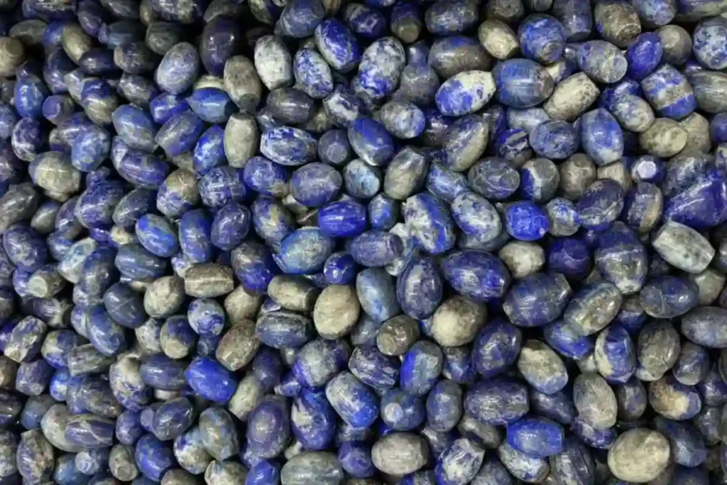 Visual verification of what does lapis lazuli look like in a volume inventory lot of rounded tube beads with white calcite streaks.