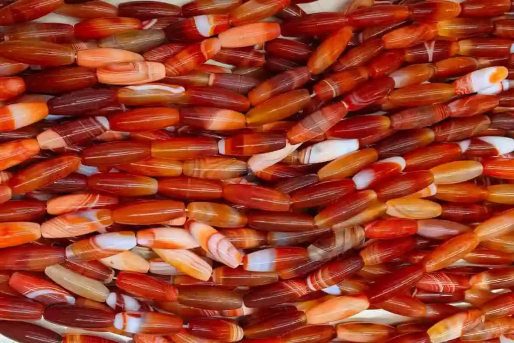 High quality striped Carnelian Agate strand beads in a long oval shape for B2B supply.