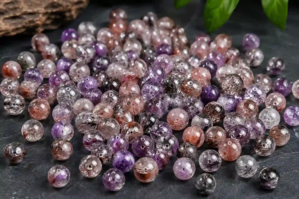 Super Seven Crystal meaning showcased through polished loose gemstone beads with natural purple and smoky inclusions for jewelry making