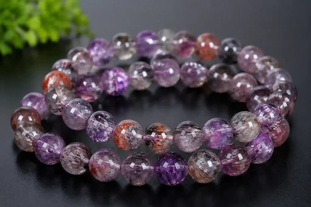 Super Seven Crystal meaning represented by handmade crystal bracelet beads with rich amethyst and rutile patterns