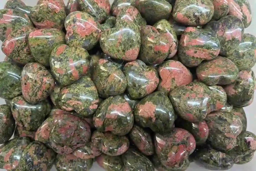 Polished Unakite heart stones carved from natural rock, perfect for customers exploring the Unakite meaning in emotional healing.