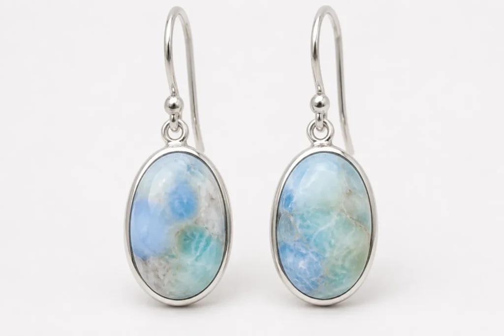 Blue opal earrings with pale blue marbled stones showing blue opal meaning in elegant gemstone jewelry