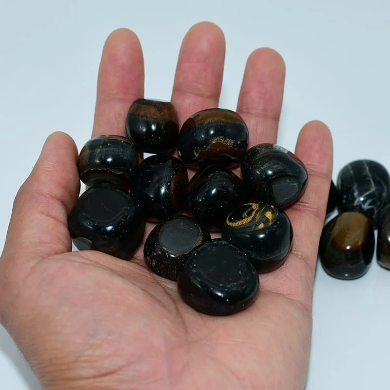 Blue Tiger Eye Tumbled Stone Wholesale – stones held in hand for size reference