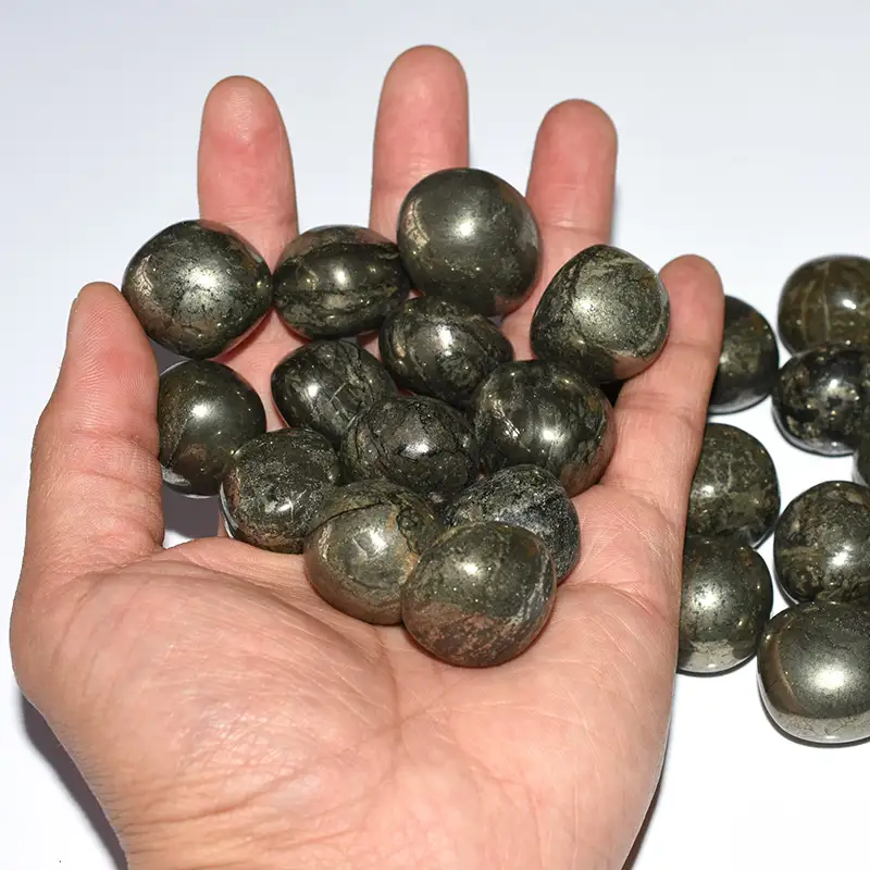 Pyrite Tumbled Stone Wholesale polished crystal stones displayed on hand