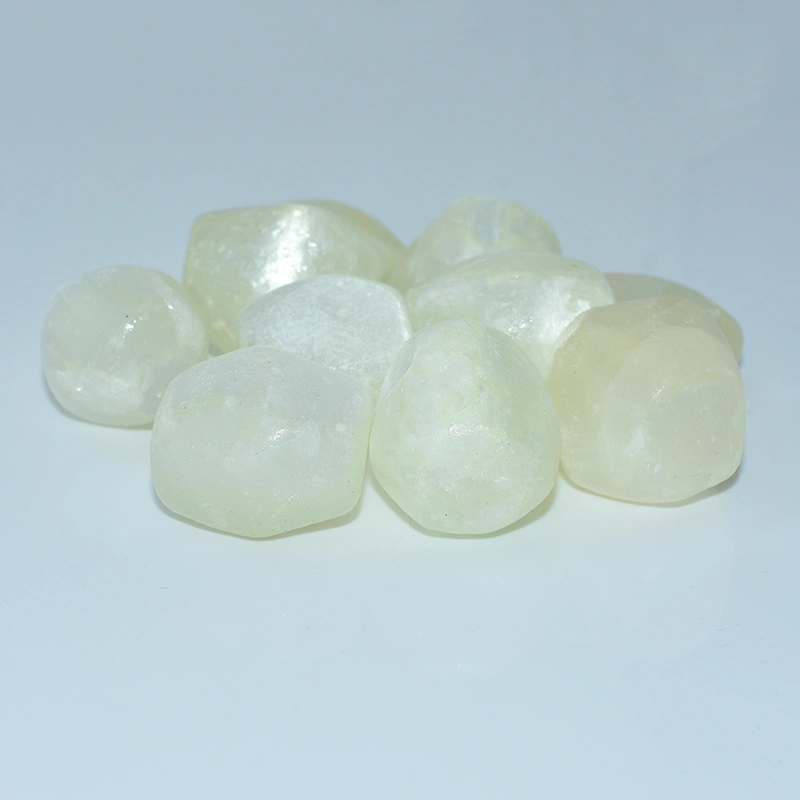 20-30mm Tumbled Selenite Wholesale stones on a light blue background