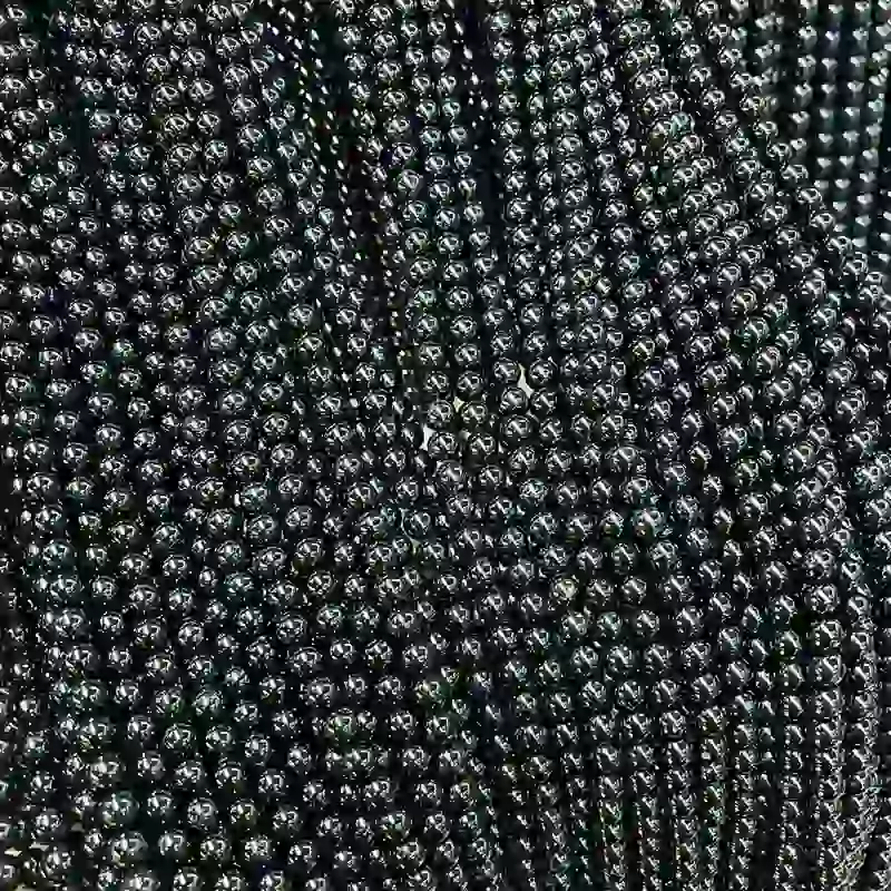 Black Tourmaline Meaning shown through polished crystal beads for protection jewelry and wholesale bracelet making