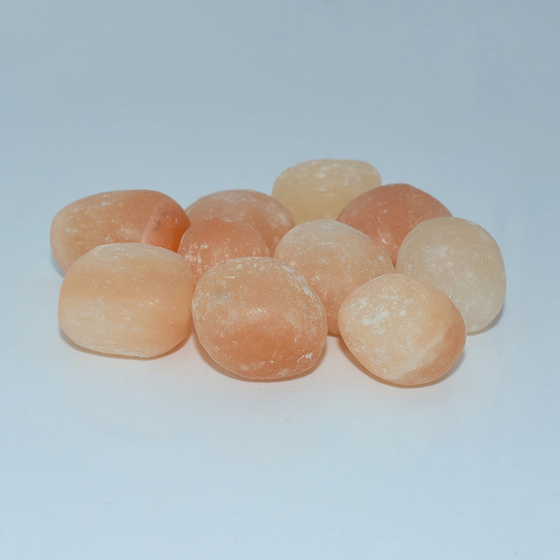Peach Selenite Tumbled Wholesale stones on a light background