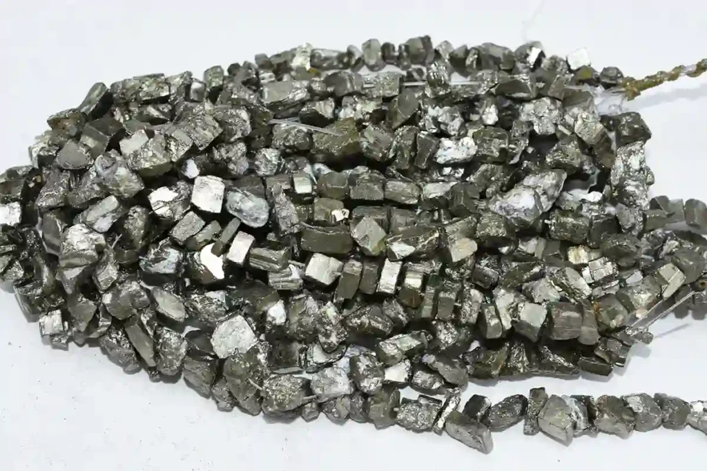 Rough pyrite crystal chip beads showing the natural Pyrite Crystal Meaning