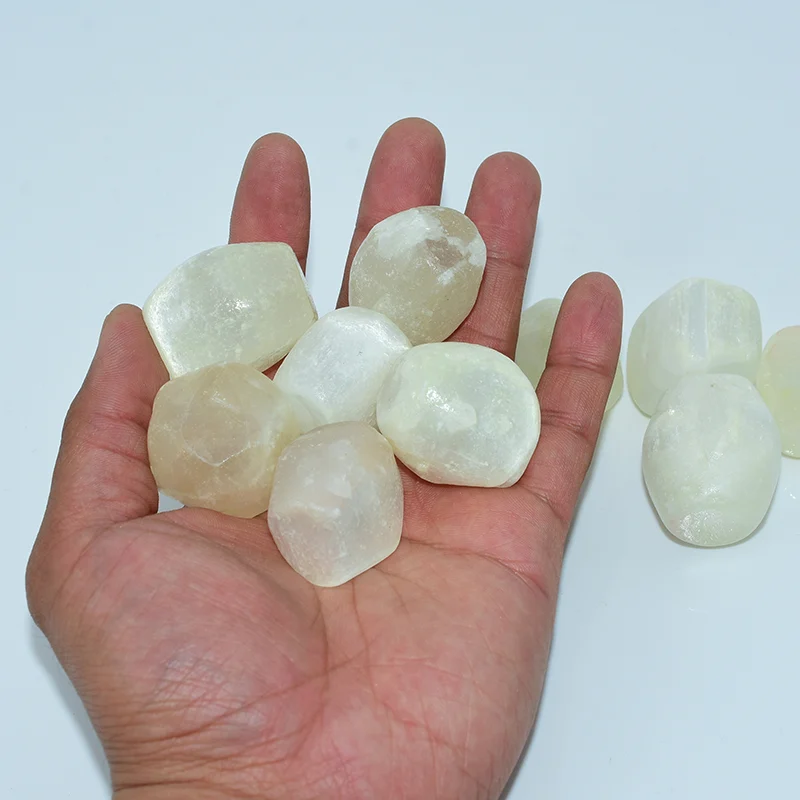 20-30mm Tumbled Selenite Wholesale stones shown on hand