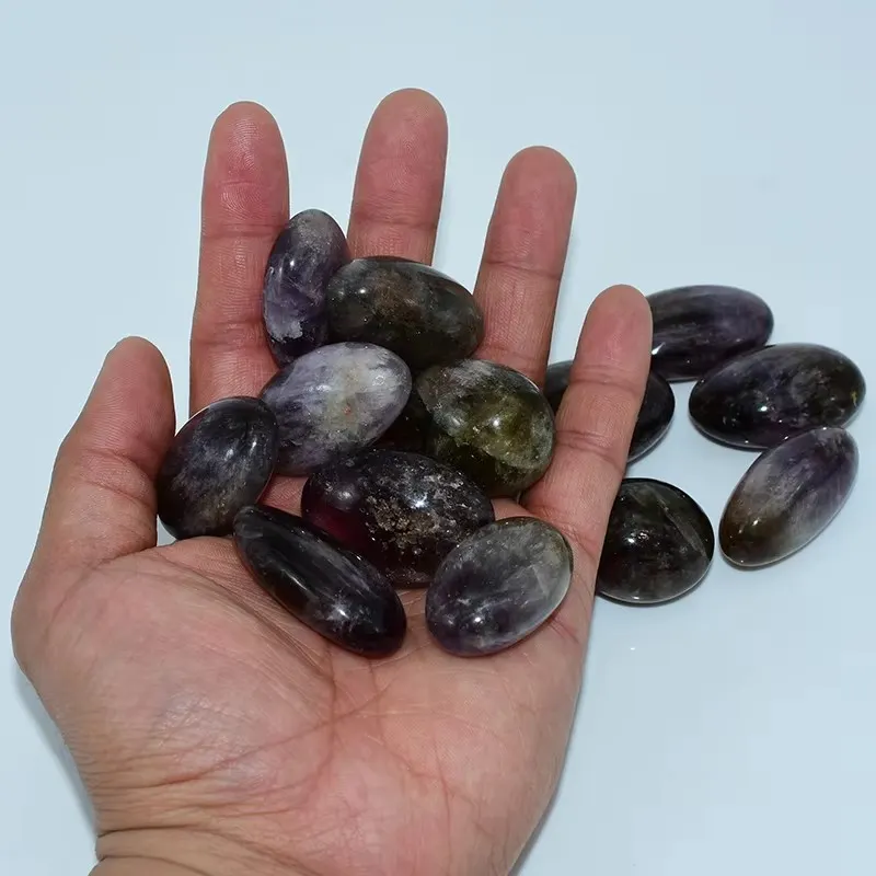 Ametrine Tumbled Stones Wholesale shown on hand with natural color variations