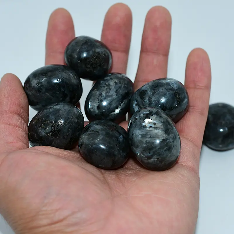 Natural Larvikite Tumbled Stone Wholesale pieces displayed by hand