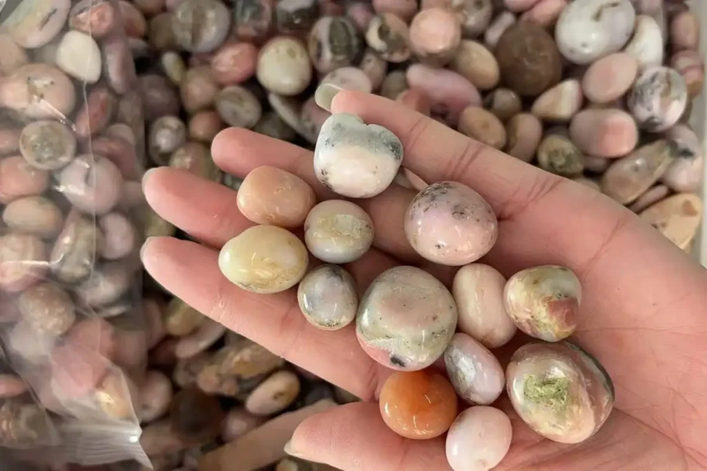 Pink Opal Meaning – Natural Pink Opal Tumbled Stones Shown by Hand