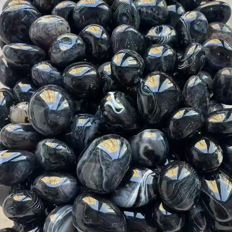 Black Agate Meaning guide featuring 20–30 mm polished black onyx tumbled stones