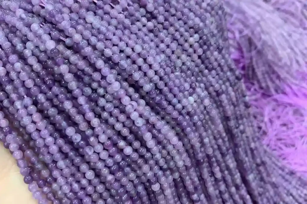 3mm Lepidolite crystal string beads showing the natural purple colors associated with Lepidolite Meaning
