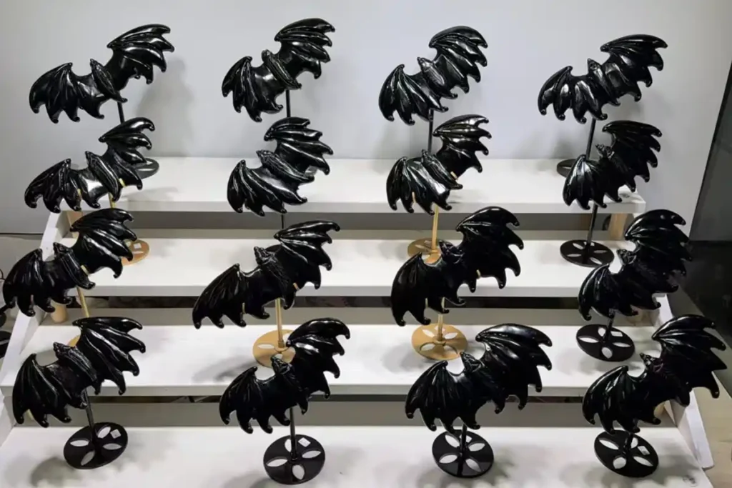 Black Obsidian vs Black Tourmaline comparison featuring polished black obsidian bat carvings