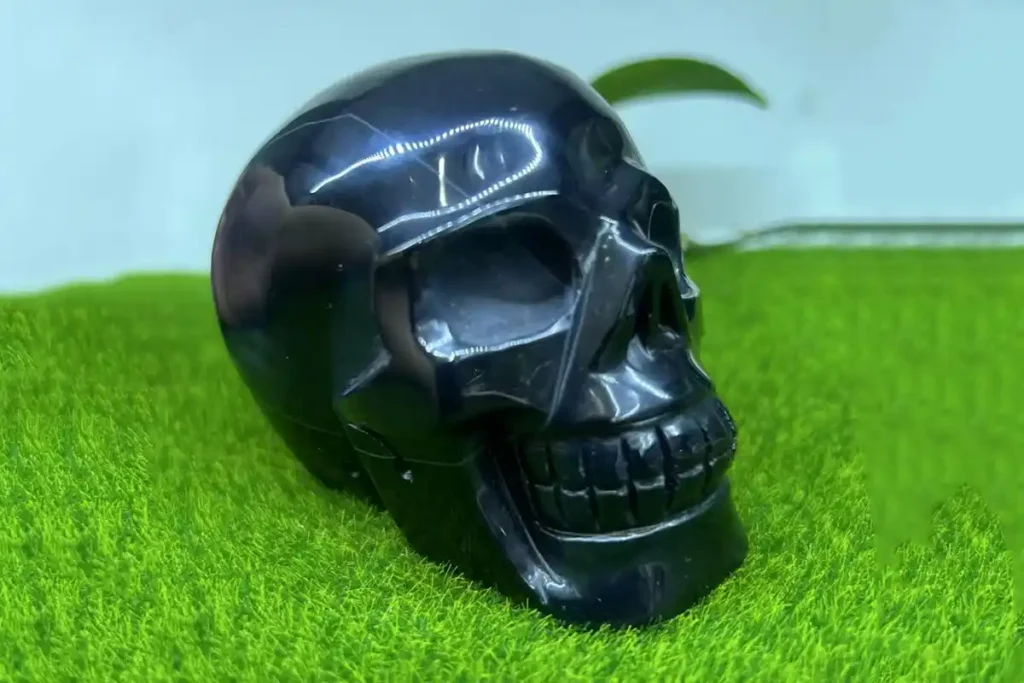 Black Agate Meaning guide featuring a polished black onyx crystal skull carving