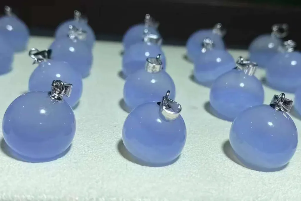 Blue Lace Agate Meaning – blue lace agate pendants displayed on a dark background