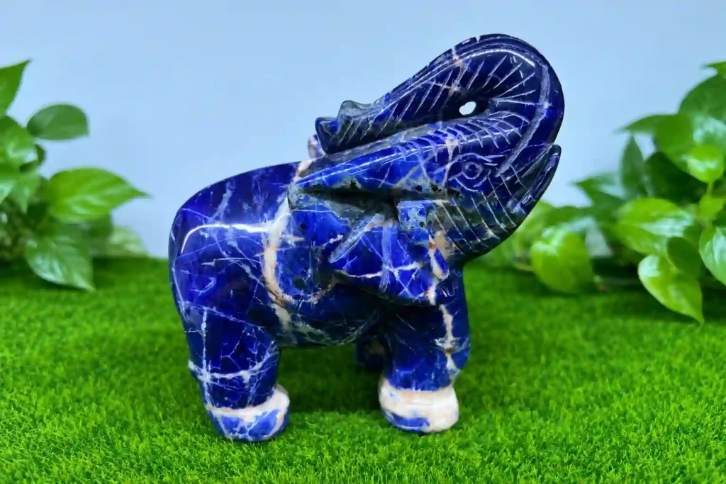Sodalite Meaning represented by a blue and white sodalite elephant carving