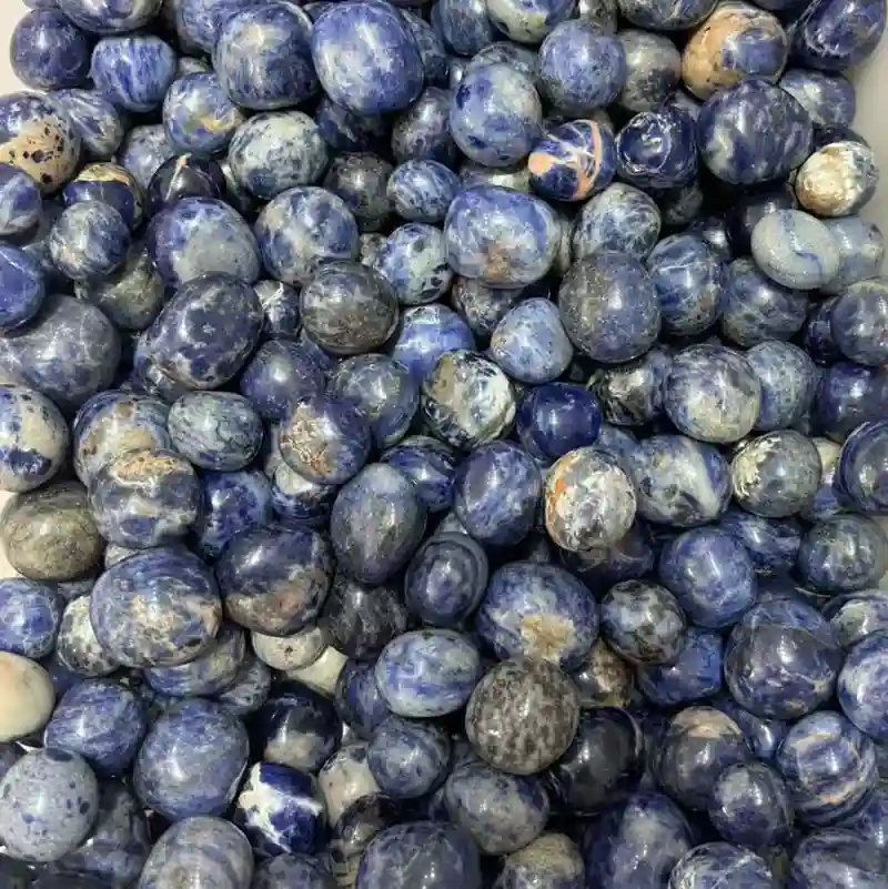 Sodalite Meaning displayed through polished blue sodalite tumbled stones