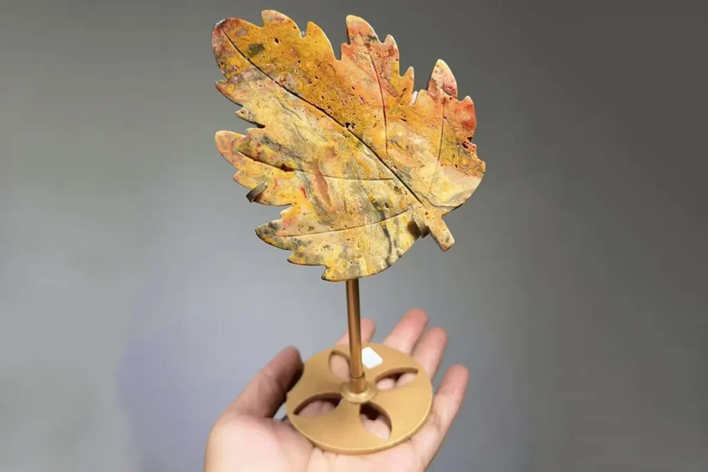 Crazy Lace Agate leaf carving on a decorative stand – Crazy Lace Agate meaning