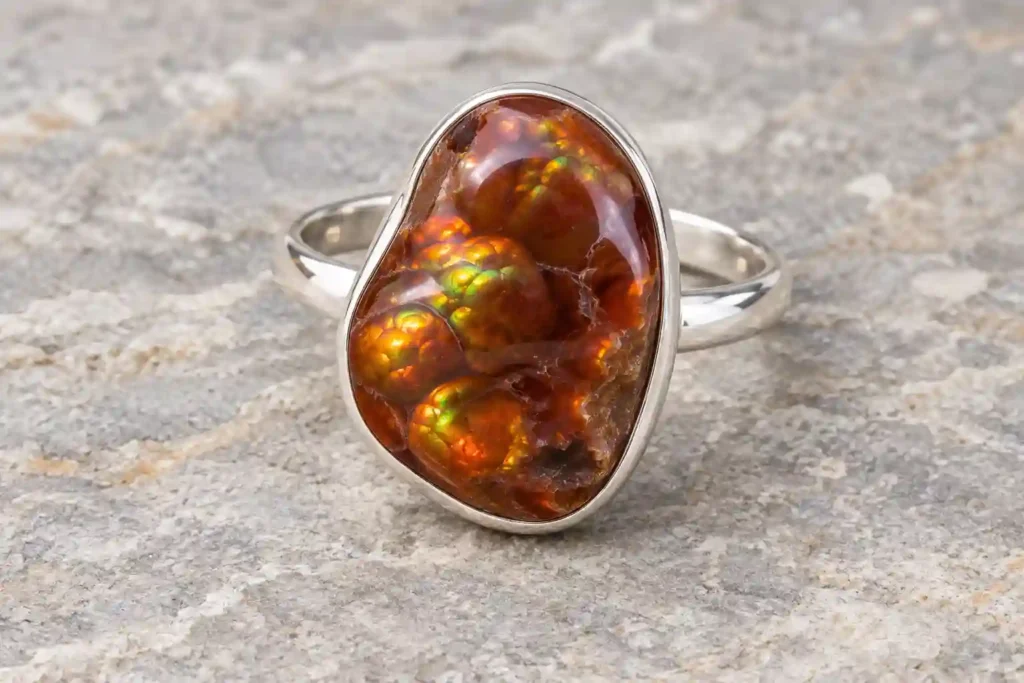 Fire Agate Meaning illustration showing a brown stone ring with green and orange iridescence