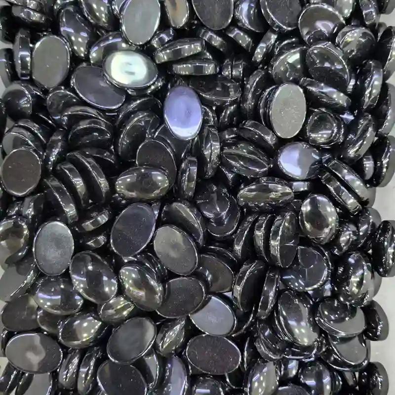 Hematite Benefits displayed with polished black and metallic gray cabochons for jewelry making