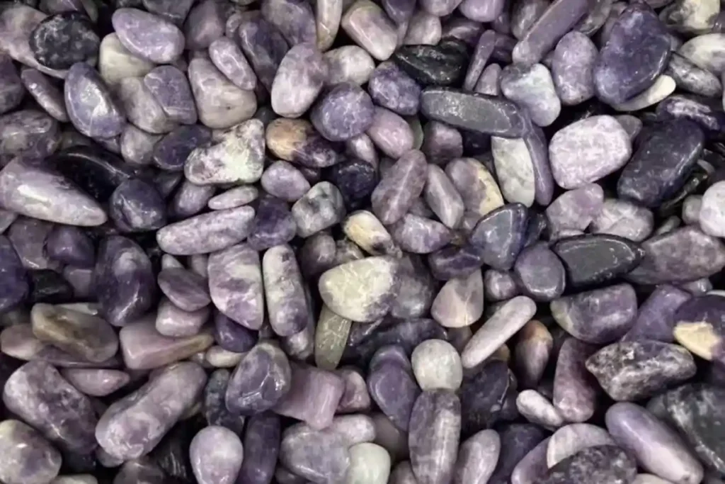 Natural Lepidolite chip stones with purple and white mineral patterns related to Lepidolite Meaning