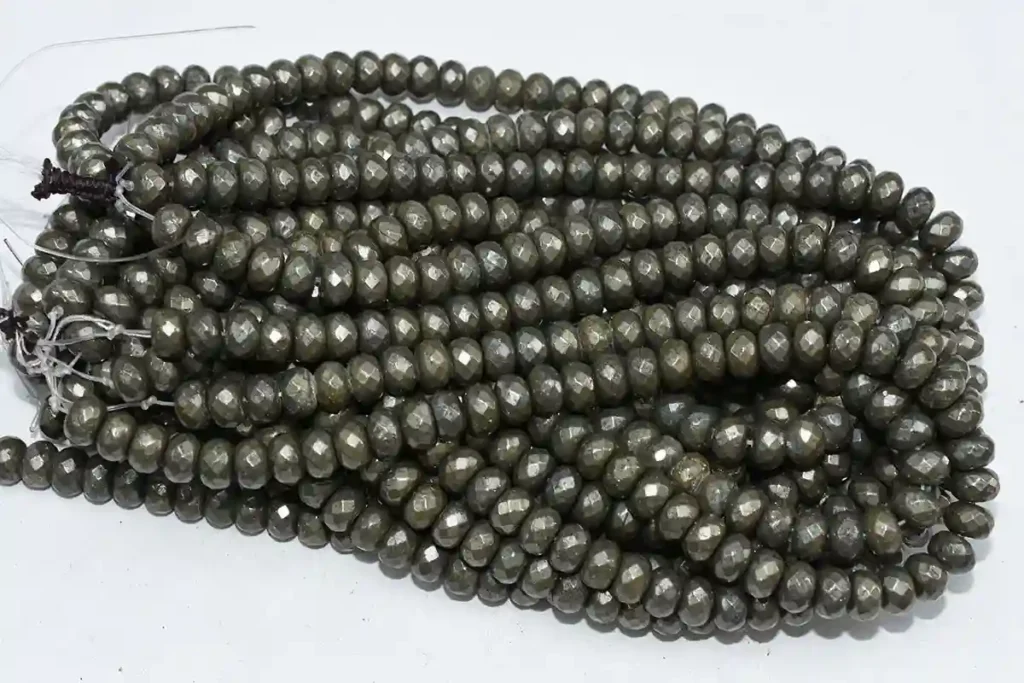 Pyrite Stone Benefits shown in faceted round pyrite bead strands