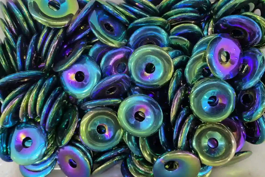 Hematite Benefits featuring rainbow-coated hematite donut pendants with colorful metallic patterns