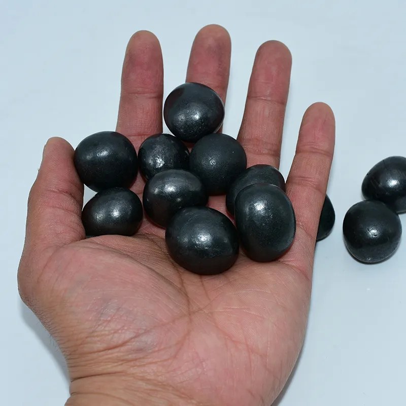 Shungite Tumbled Stones Wholesale held for size reference