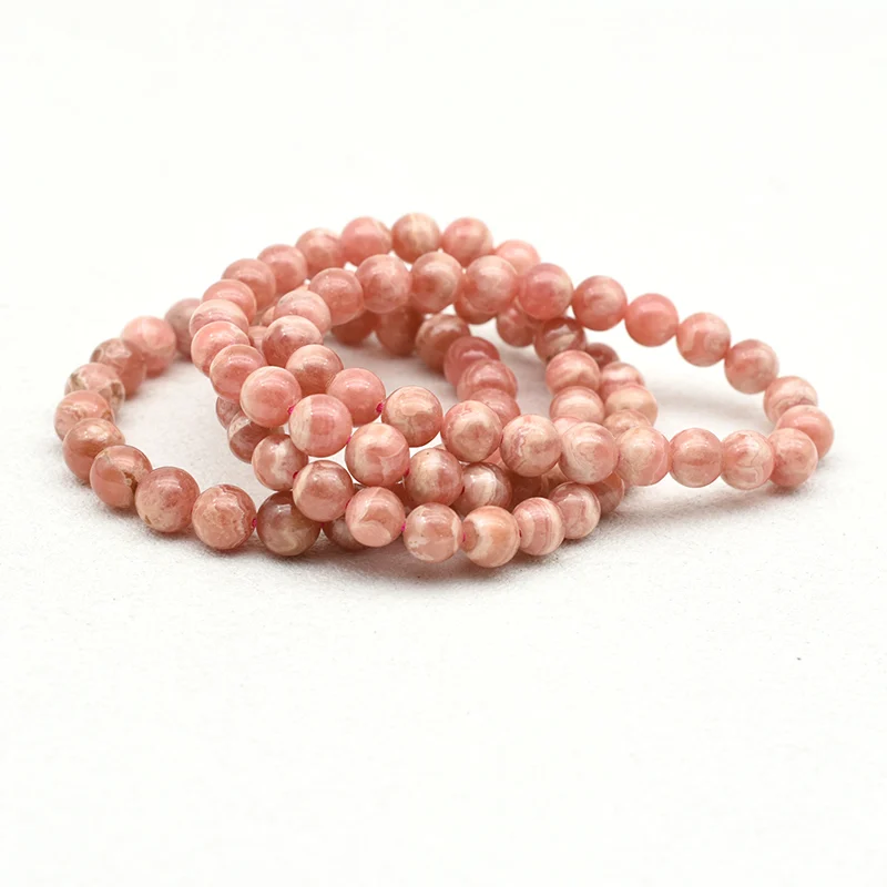 Rhodochrosite Bracelet Wholesale – three pink round bead bracelets with cream-colored banding