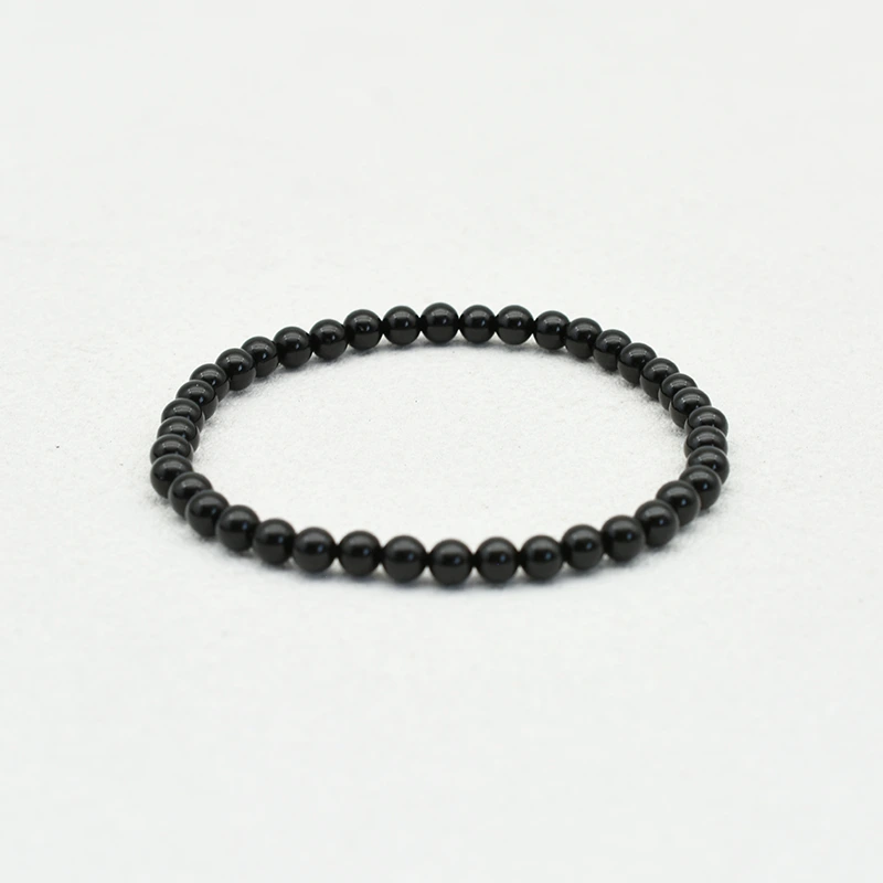 Black Spinel Bracelets Wholesale – 4mm polished black round bead bracelet on a white background.