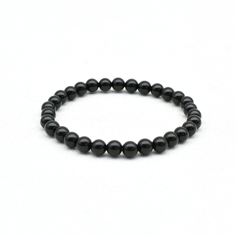 Black Spinel Bracelets Wholesale – 6mm polished black round bead bracelet on a white background.