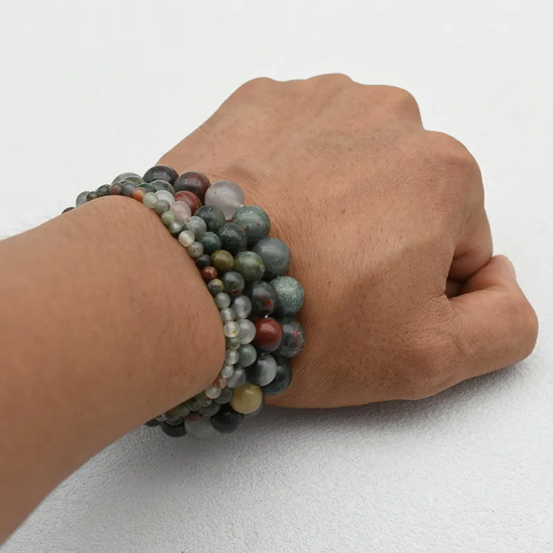 African Bloodstone Bracelet Wholesale showing beaded bracelets worn together on a wrist