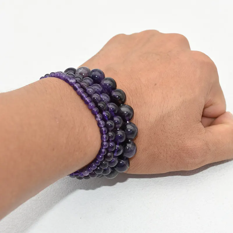 Amethyst Bracelet Wholesale showing purple bead bracelets stacked on a wrist
