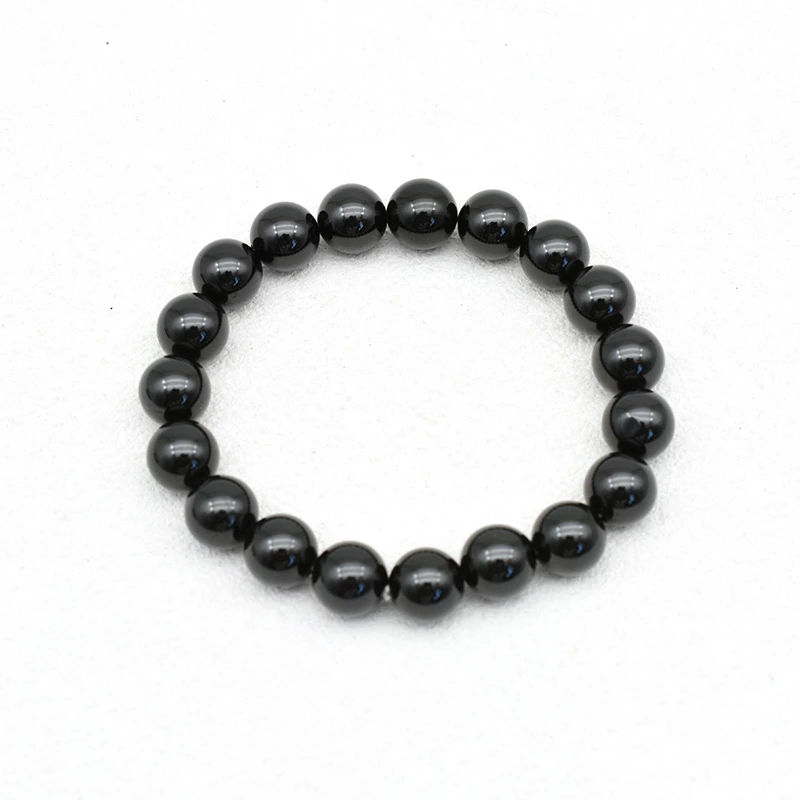 Black Spinel Bracelets Wholesale – top view of a polished black round bead bracelet on a white background.