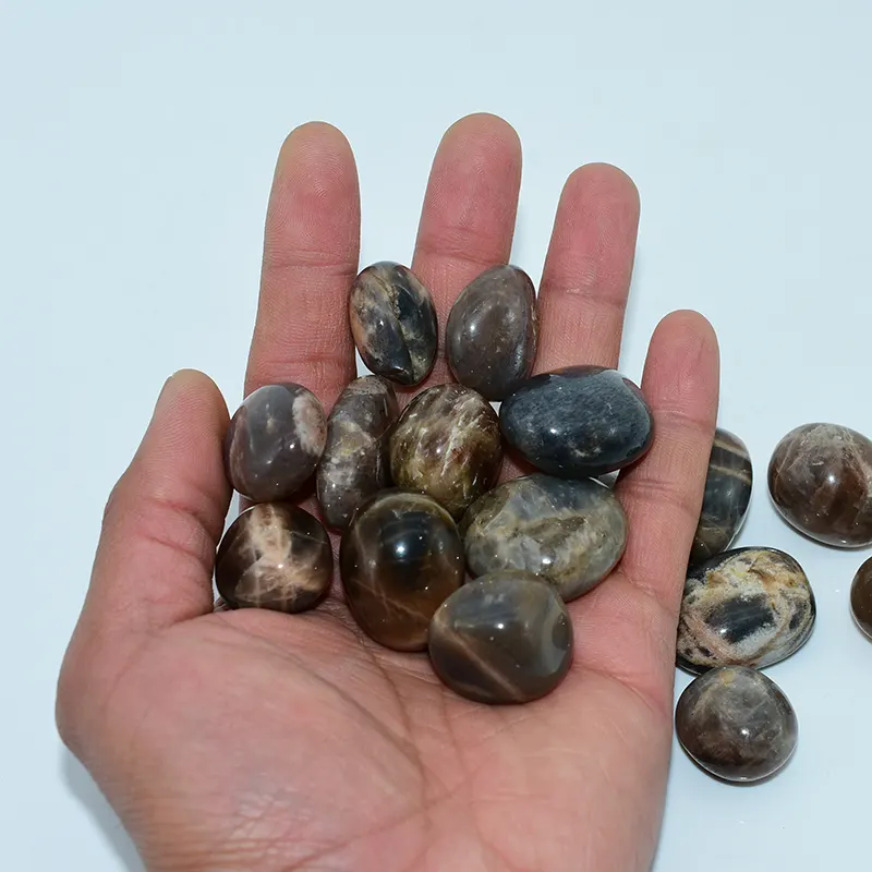 Black Sunstone Tumbled Stone Wholesale – handful of polished stones showing their size and rounded shapes
