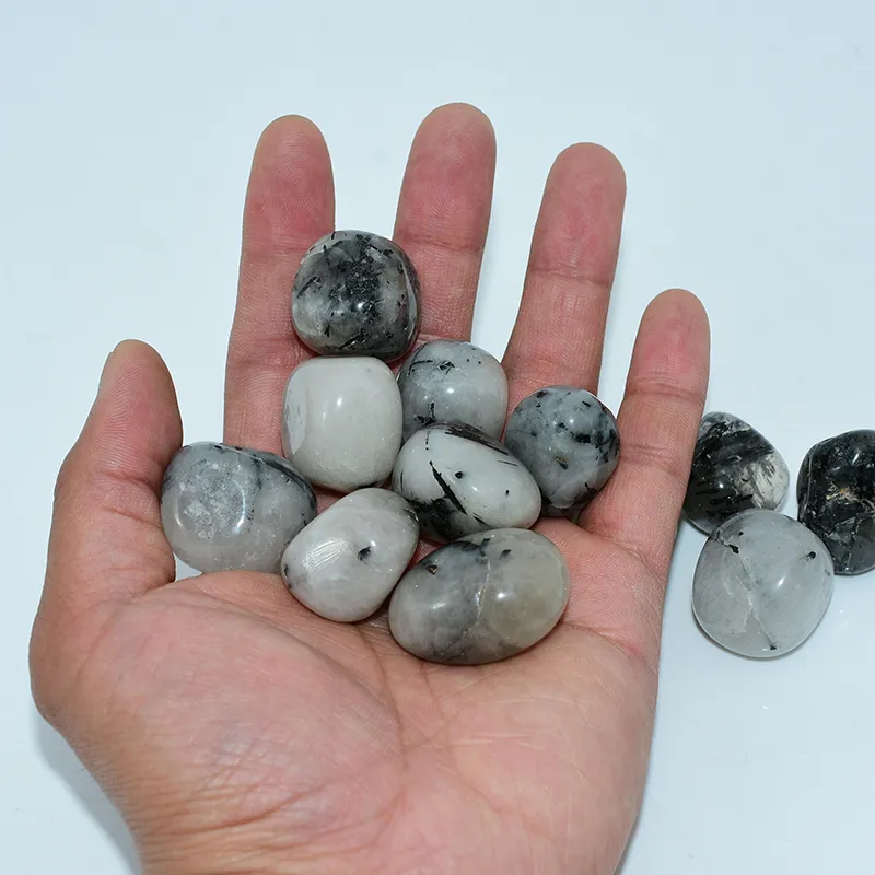 Tumbled Tourmalinated Quartz Wholesale – mixed polished stones displayed in an open palm