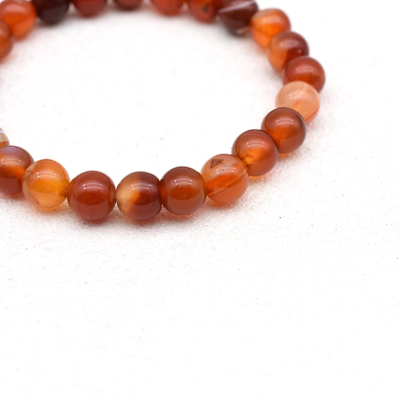 Carnelian Bracelet Wholesale close-up showing round beads with red, orange, and pale bands
