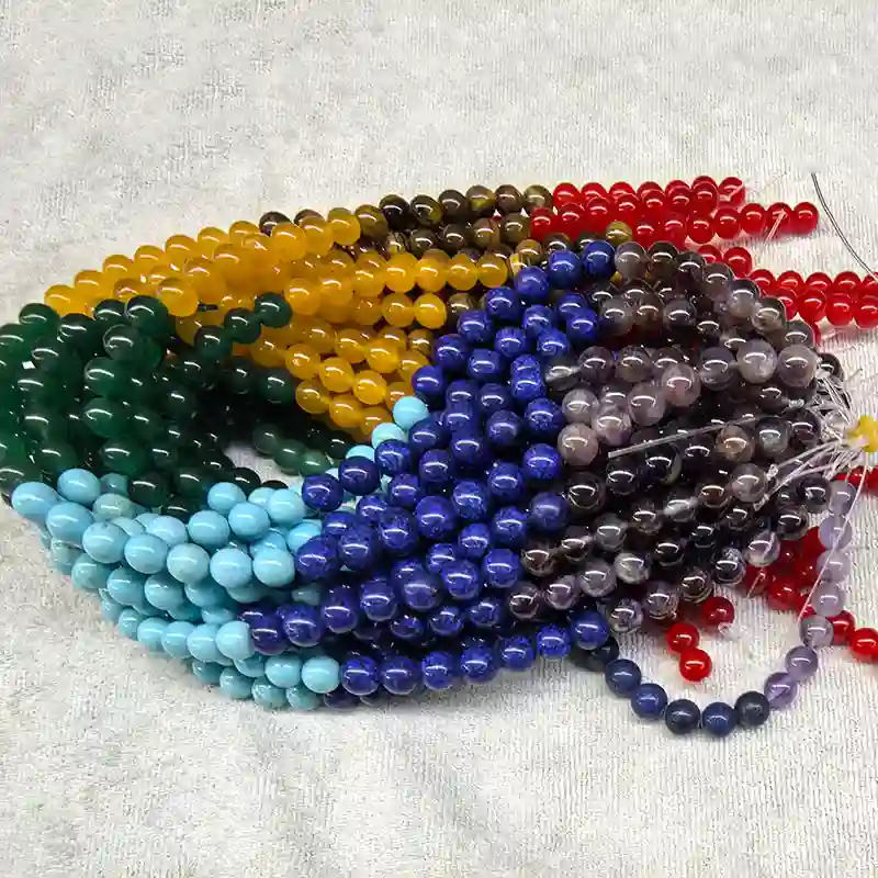 Chakra Beads Wholesale – multicolor bead strands arranged on a light background