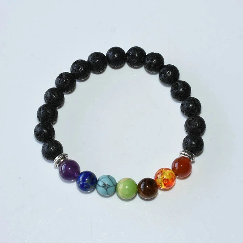 Chakra Bracelets Wholesale showing a top view of a single black lava bead bracelet with seven colored beads