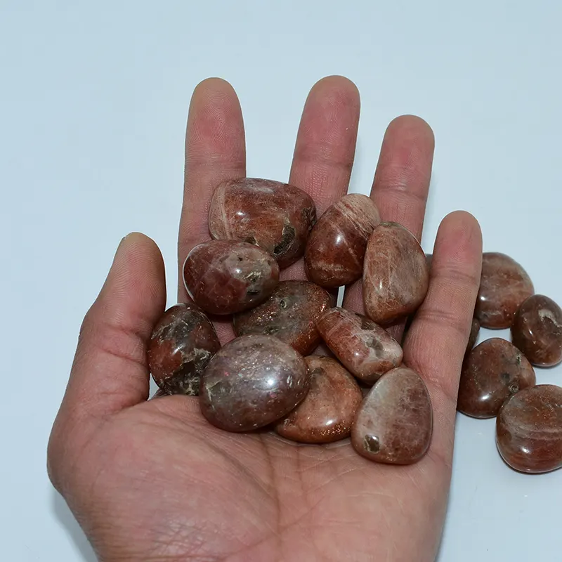 Golden Sunstone Tumbled Stone Wholesale – handheld stones showing varied shapes and sizes