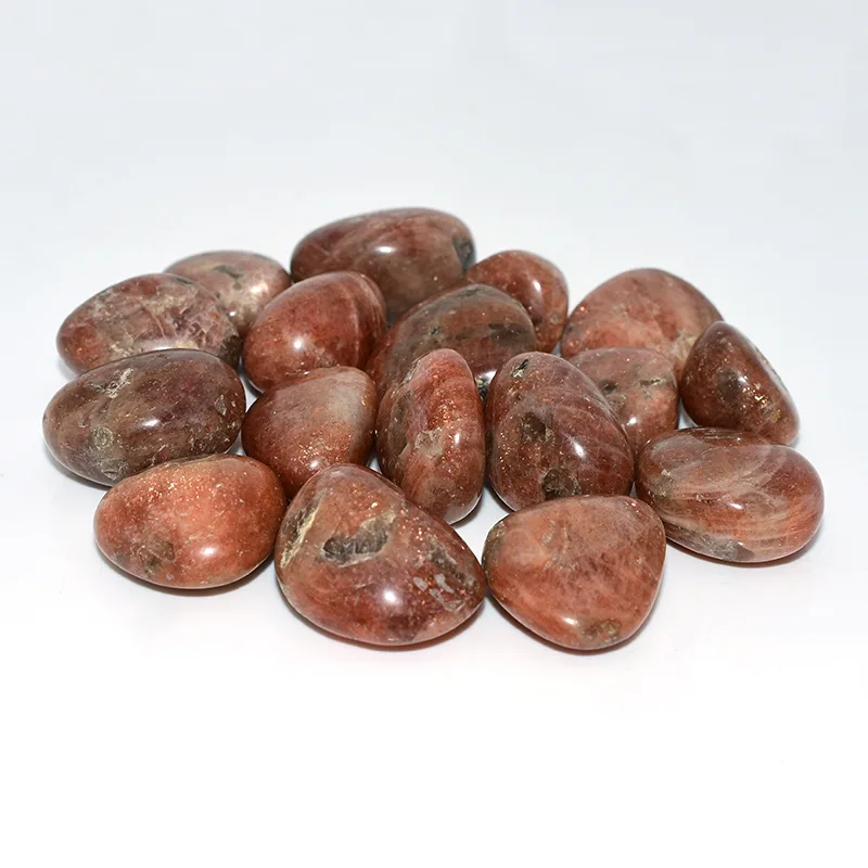 Golden Sunstone Tumbled Stone Wholesale – grouped reddish-brown tumbled stones on a white background