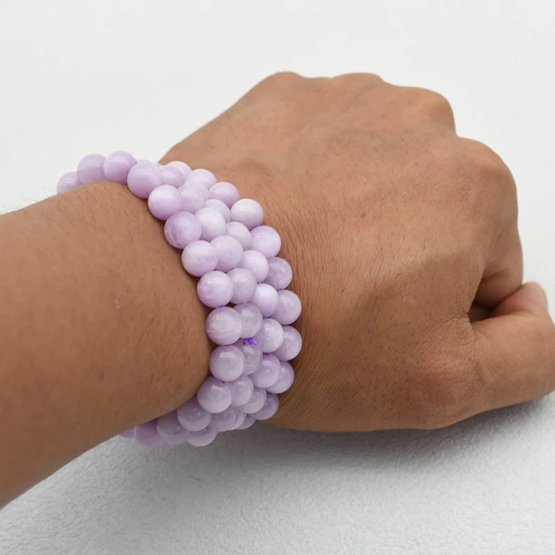 Kunzite Bracelet Wholesale showing multiple pale purple bead bracelets worn on a wrist
